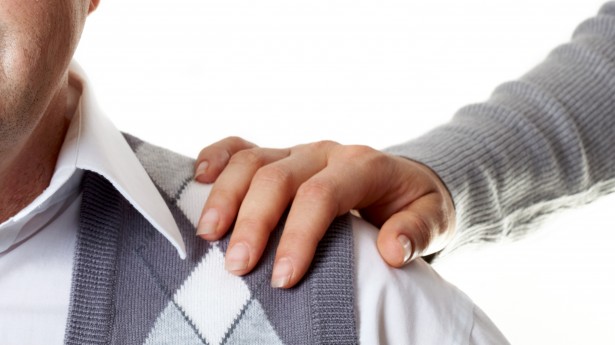 Portrait of a senior man with a female hand on his shoulder